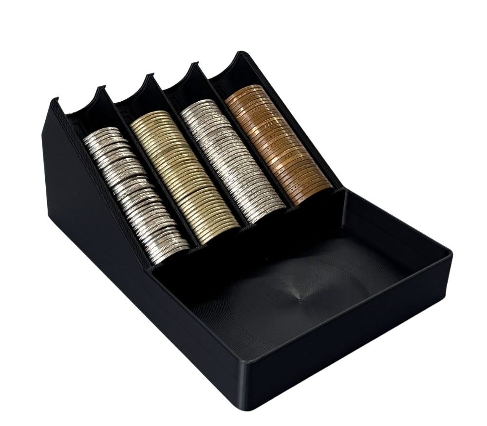 Black 3D printed coin sorter with four angled channels holding stacks of peso coins and an open tray in front