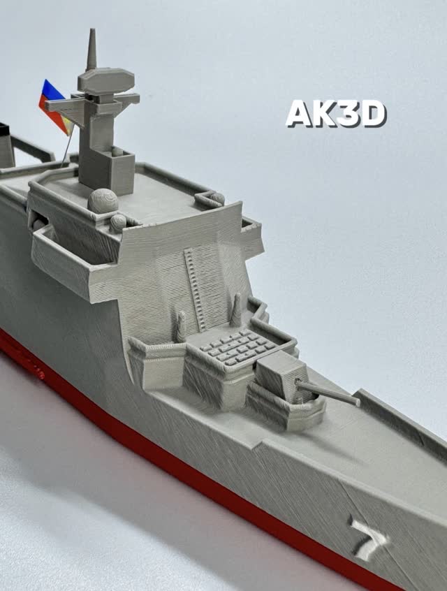 3D printed model of the frigate BRP Diego Silang with a red hull and a small Philippine flag