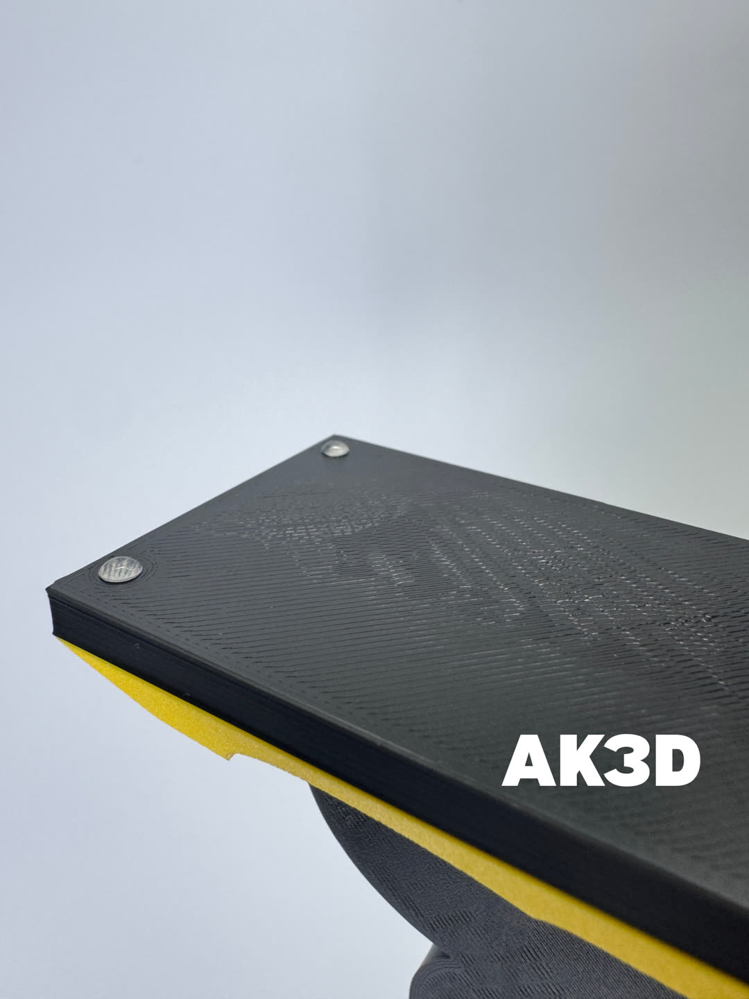 Underside of the black base with clear rubber feet in the corners