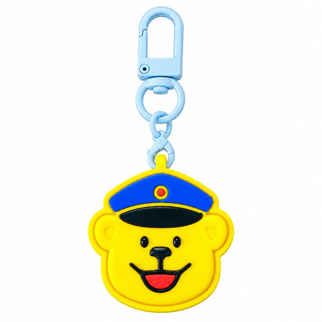 Yellow bear-face clicker of the mascot Seiharo wearing a blue cap, on a light blue clasp